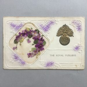 a ww1embroidered silk postcard with an embossed Royal Fusiliers cap badge on the right