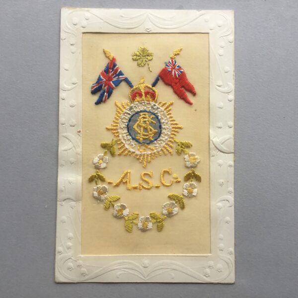 an embroidered silk postcard with an army-service-corps cap badge and British flag design