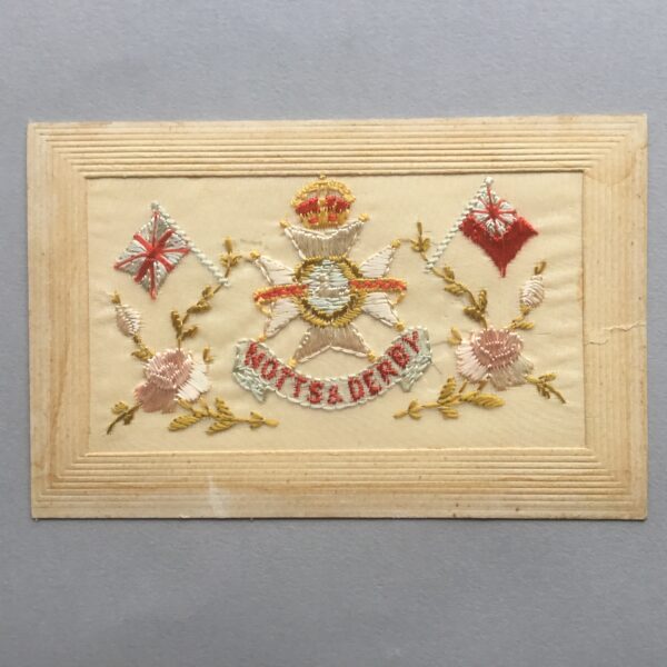 an embroidered silk postcard with the cap badge of the Notts & Derby Regiment