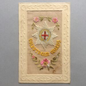 an embroidered silk postcard with the Coldstream Guards cap badge